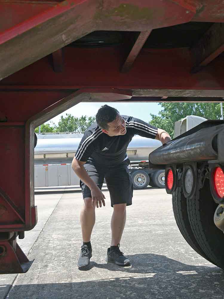 truck driver inspecting truck
