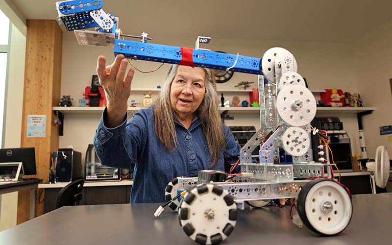 Math professor Sharon Sledge working with a robot in Central Campus robotics lab
